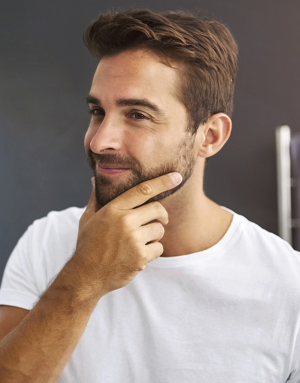 Thoughtful man with short beard and white shirt