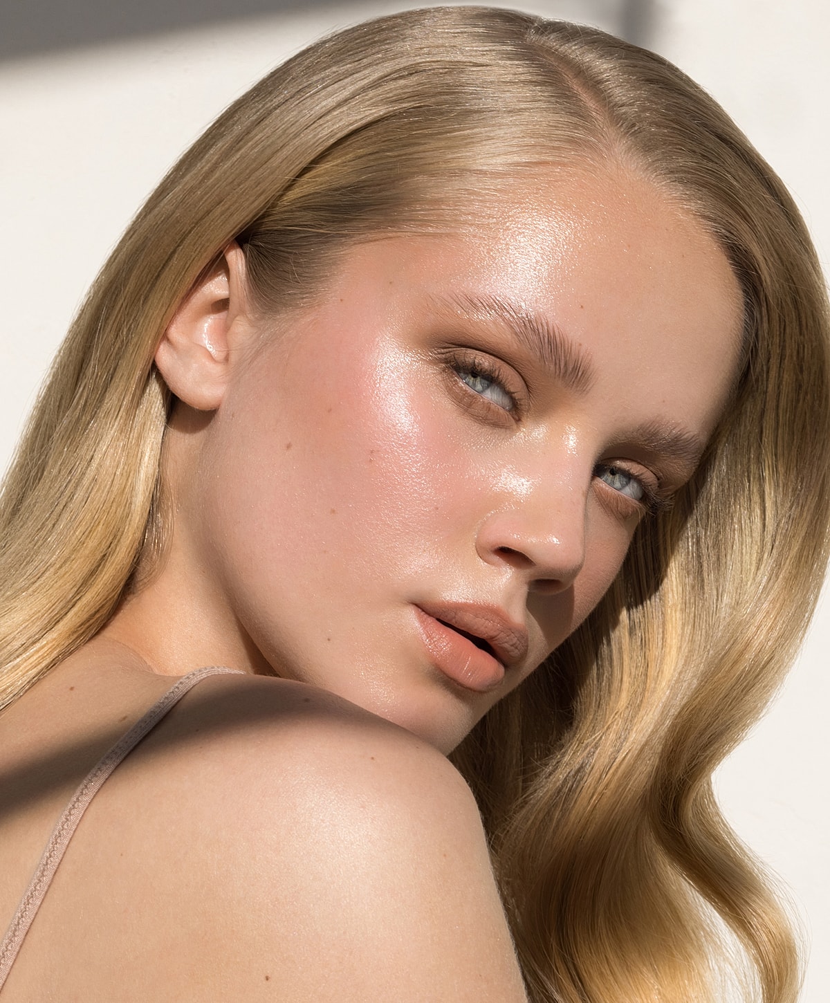 Portrait of a glowing young woman with blonde hair.
