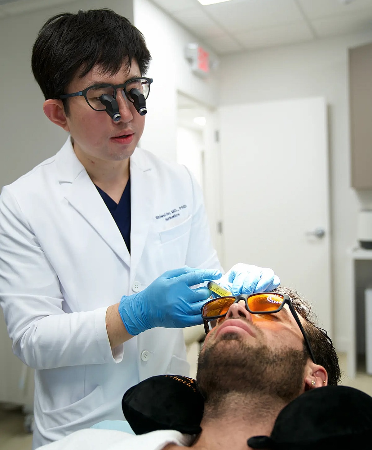 Doctor performing a cosmetic treatment on a patient.