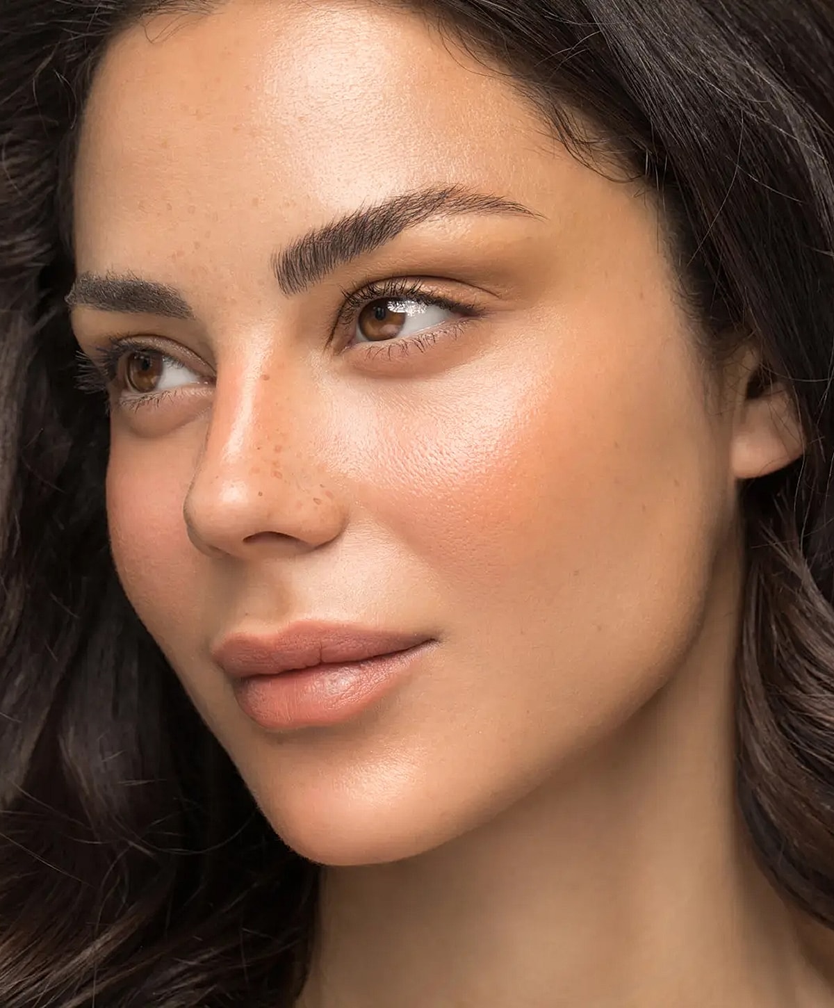 Close-up of a woman's glowing face.