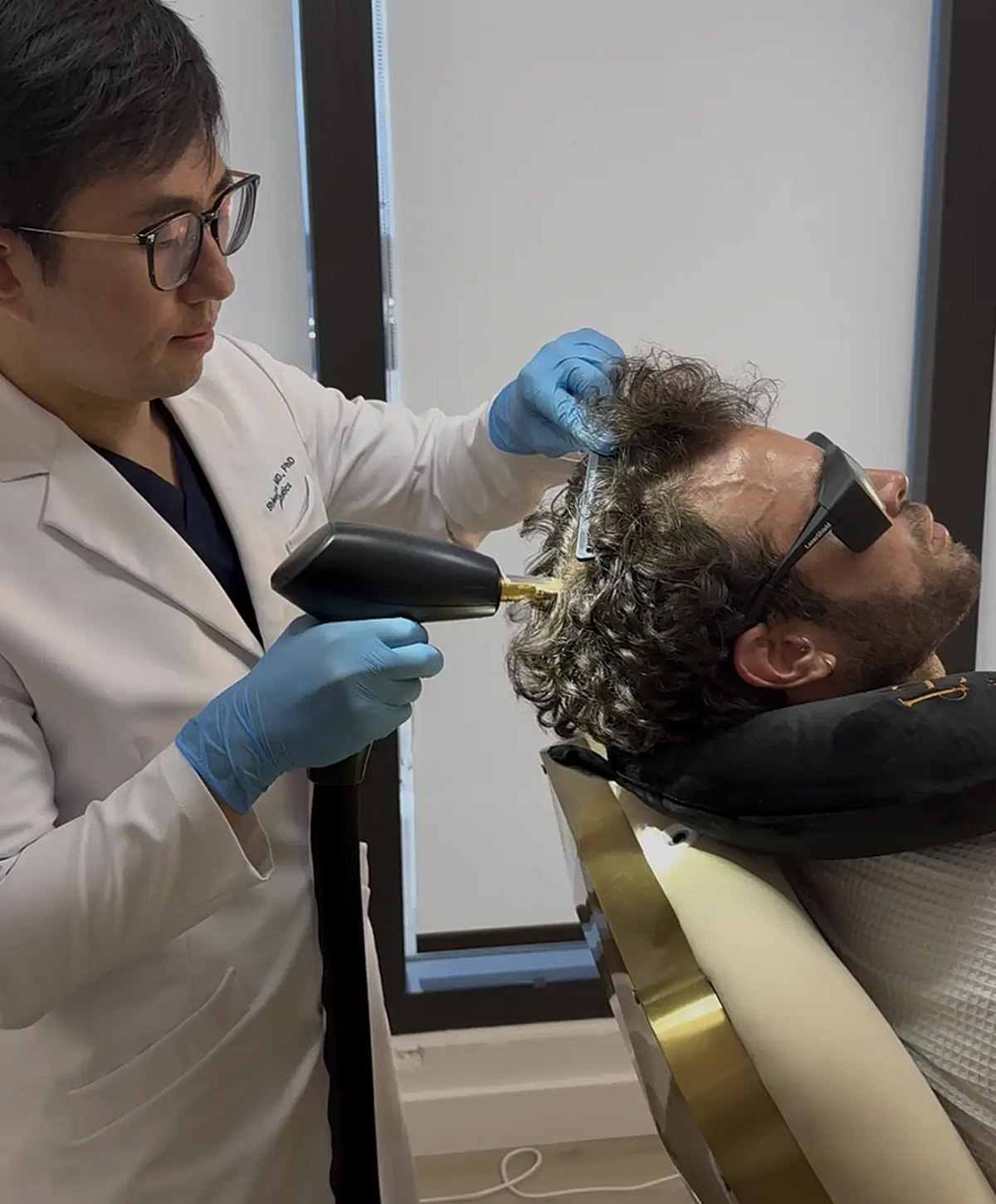 Hair treatment procedure in a clinical setting.