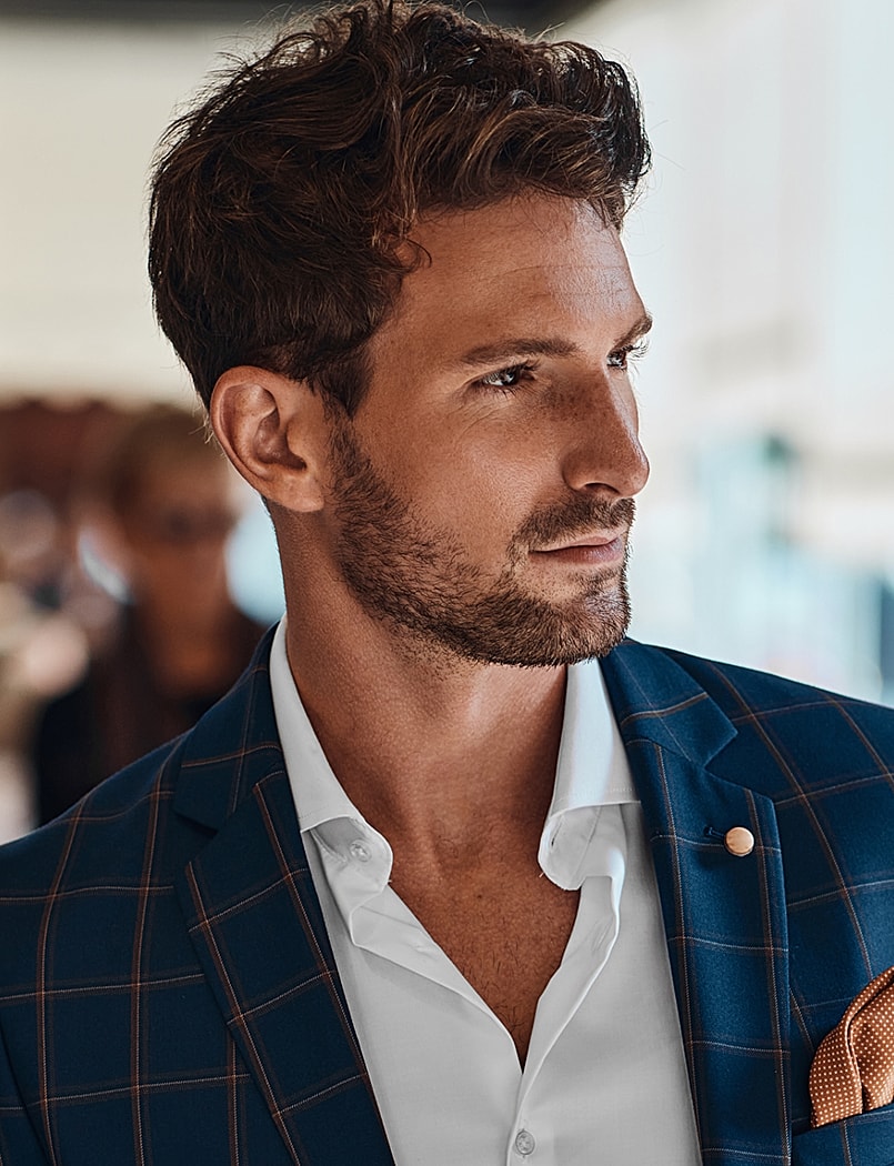 Man in stylish suit with textured hair.