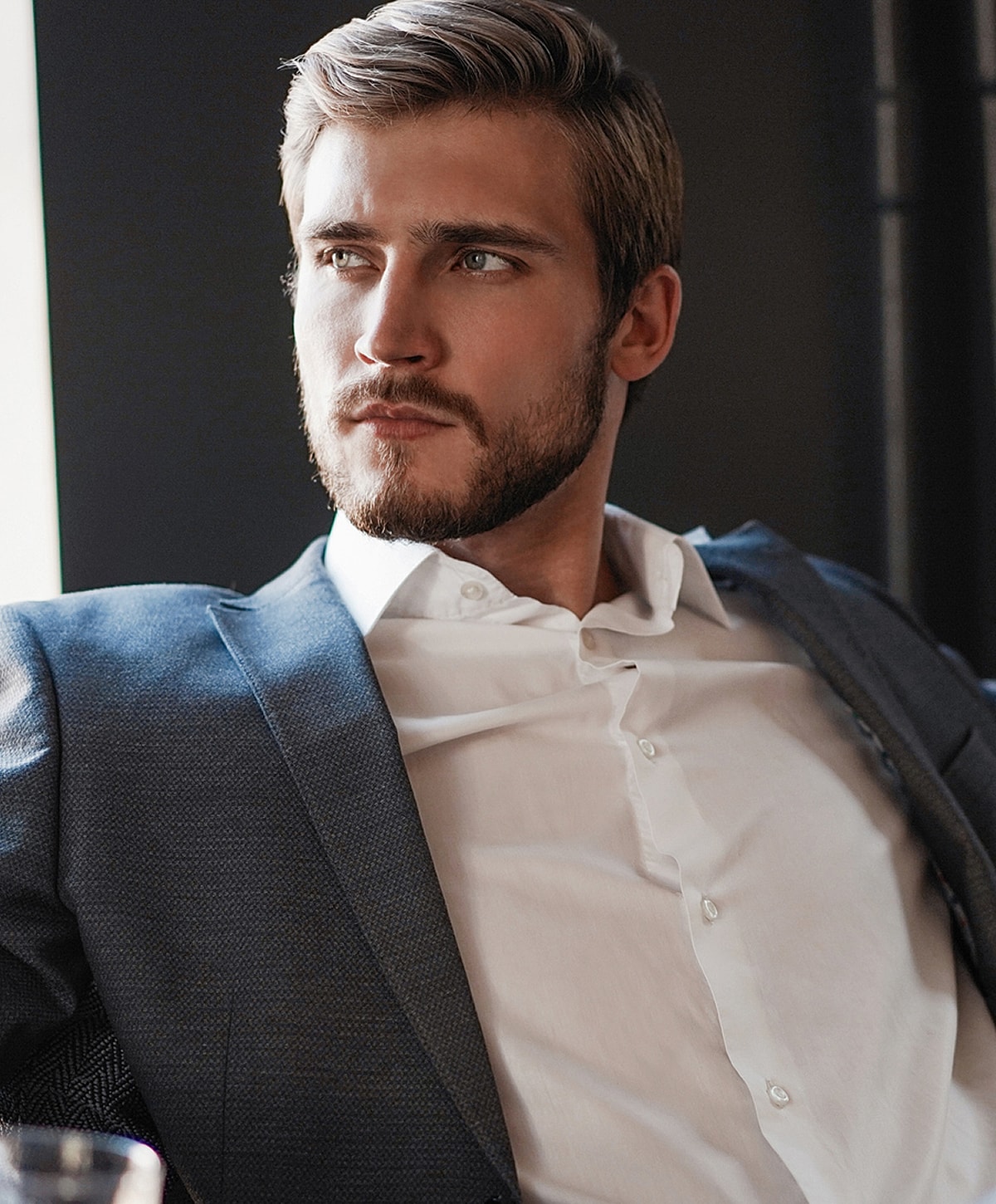 Man in suit with thoughtful expression.