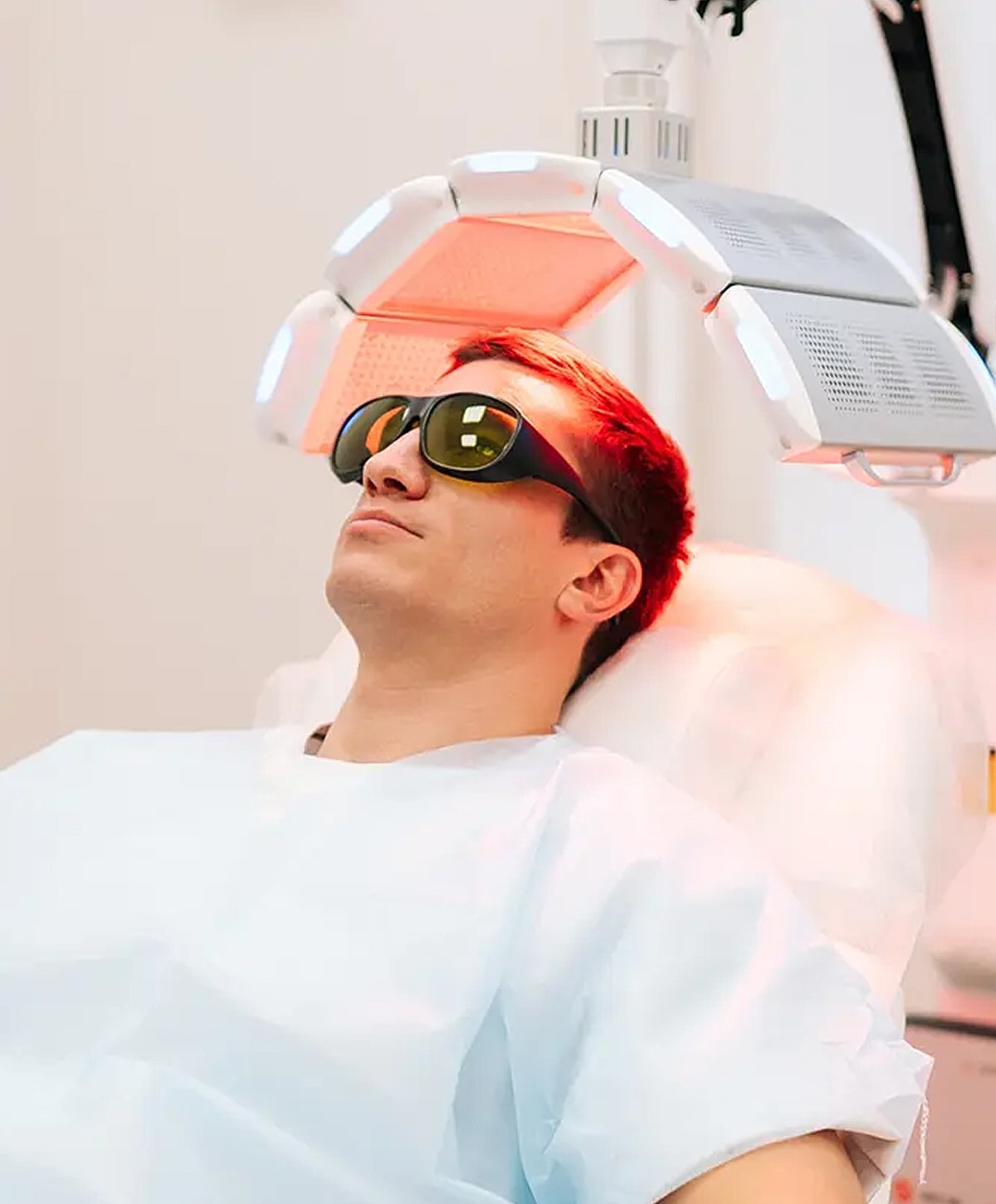 Man undergoing light therapy treatment in clinic.