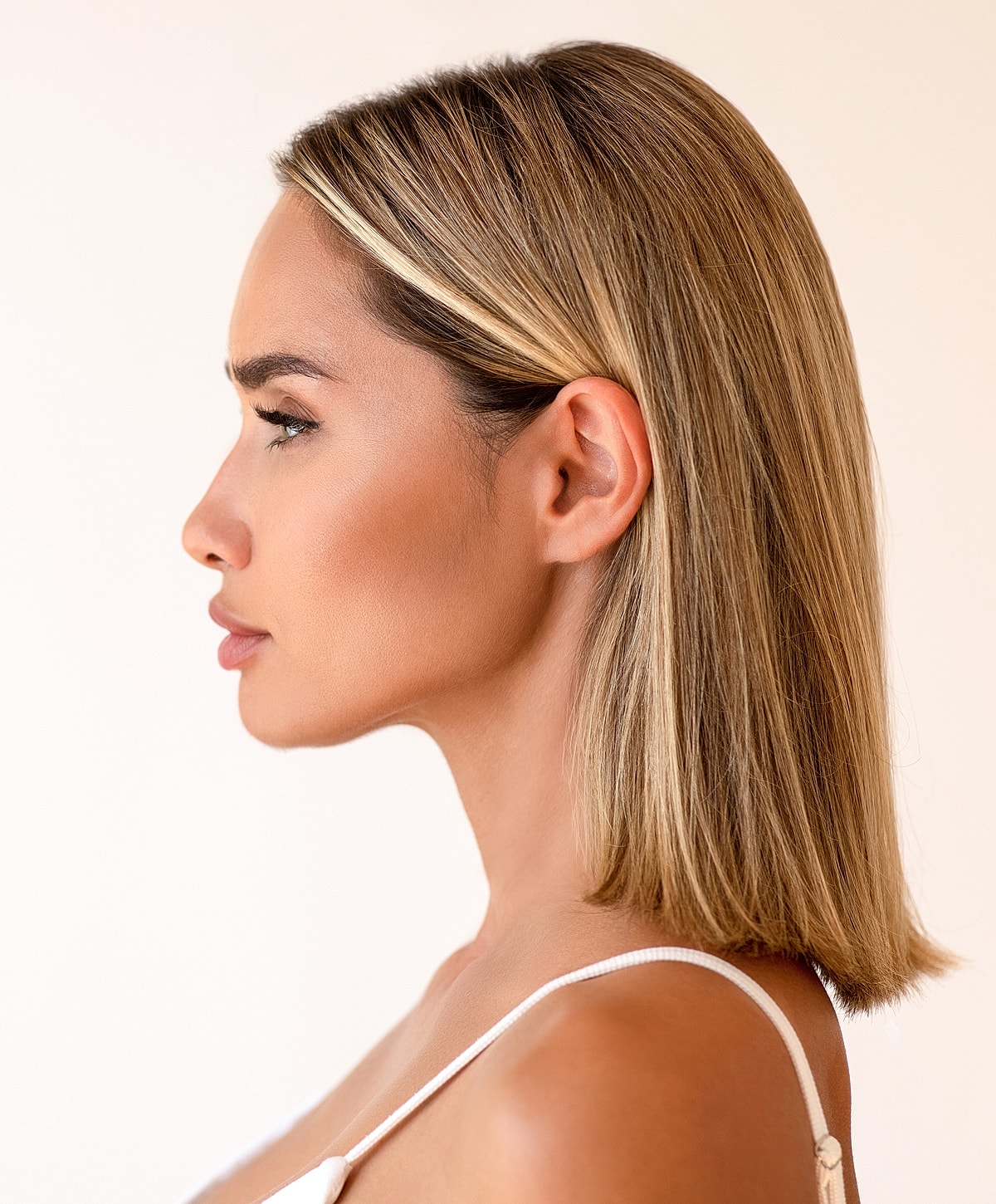 Profile of a woman with smooth, blonde hair.