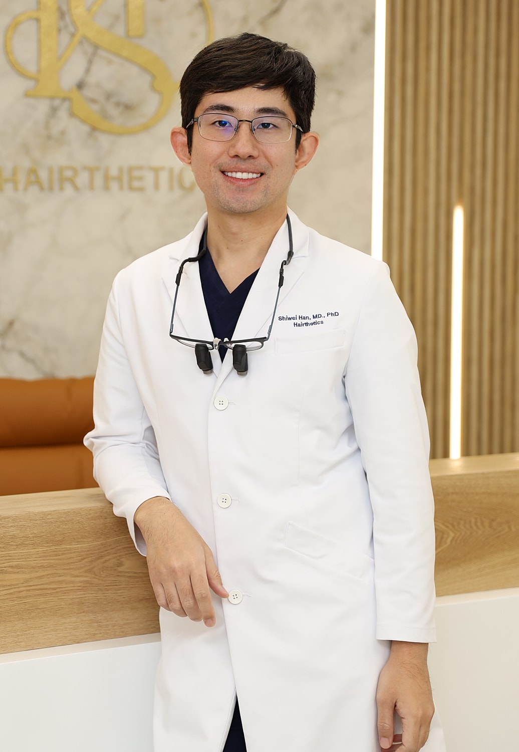 Male doctor in a white coat, smiling.