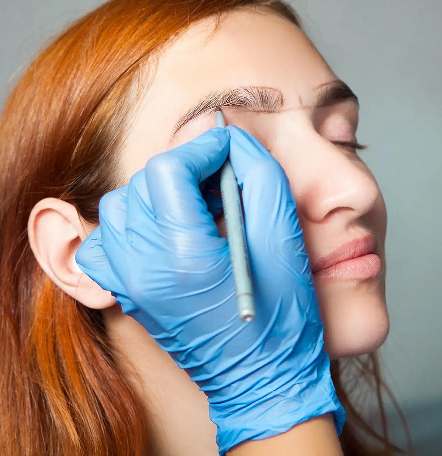 Eyebrow shaping process on a woman's face.