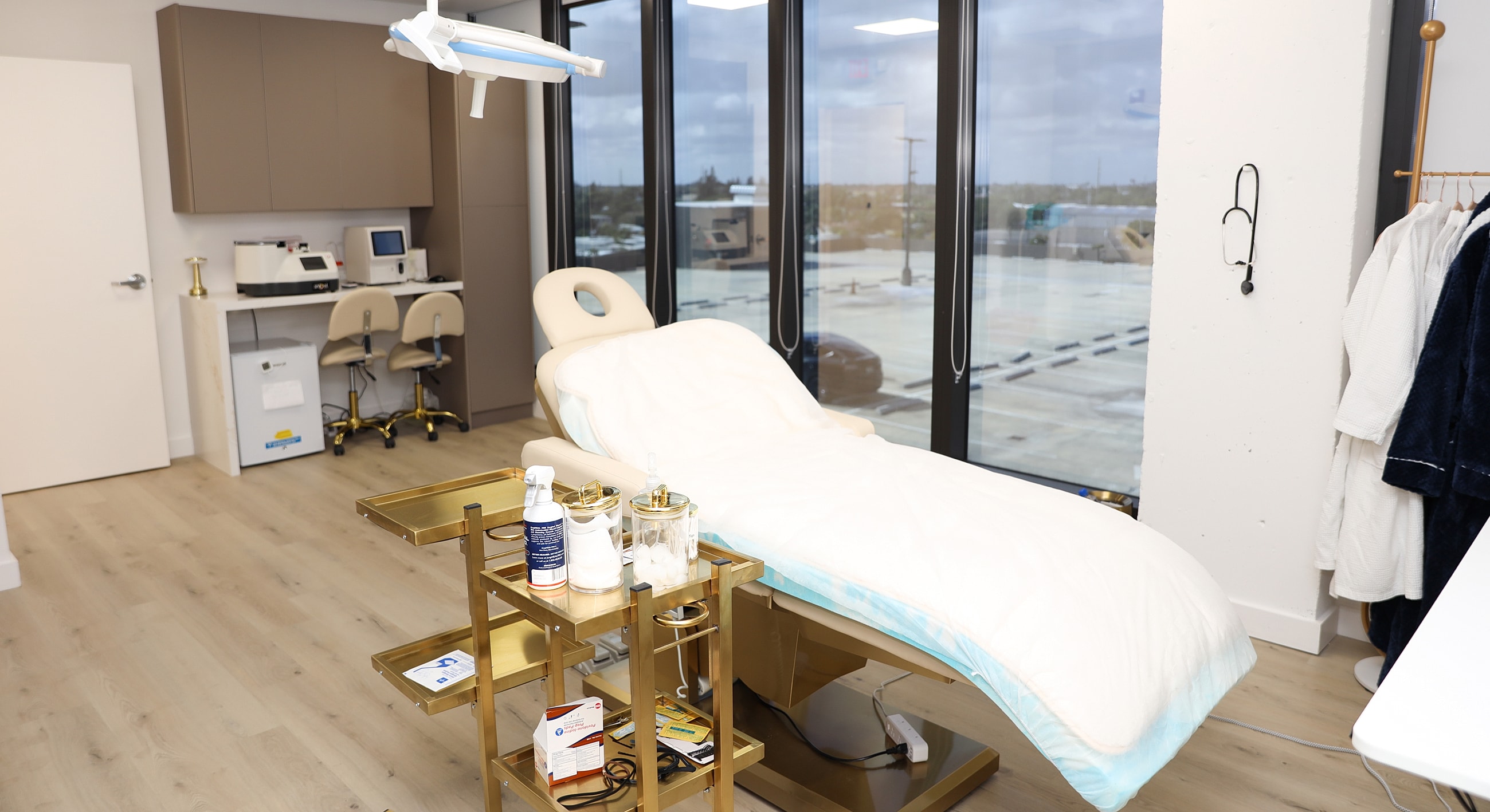 Modern aesthetic treatment room with therapy bed.