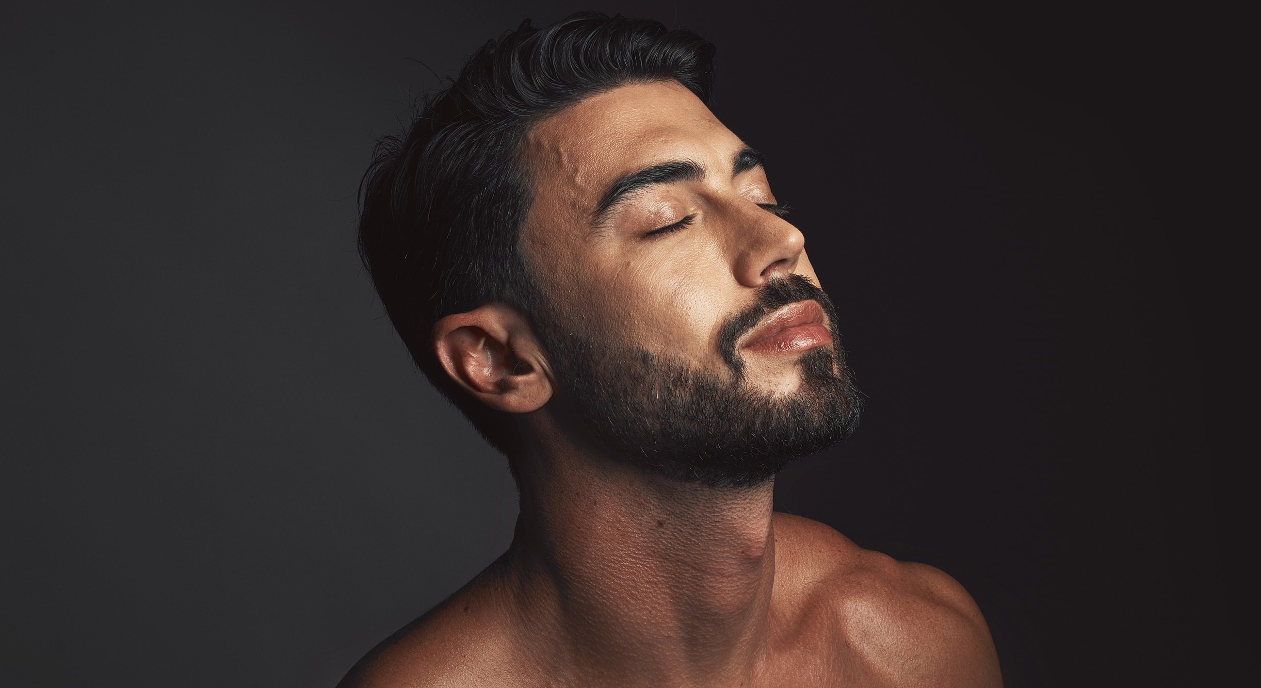 Close-up of man with eyes closed, serene expression.
