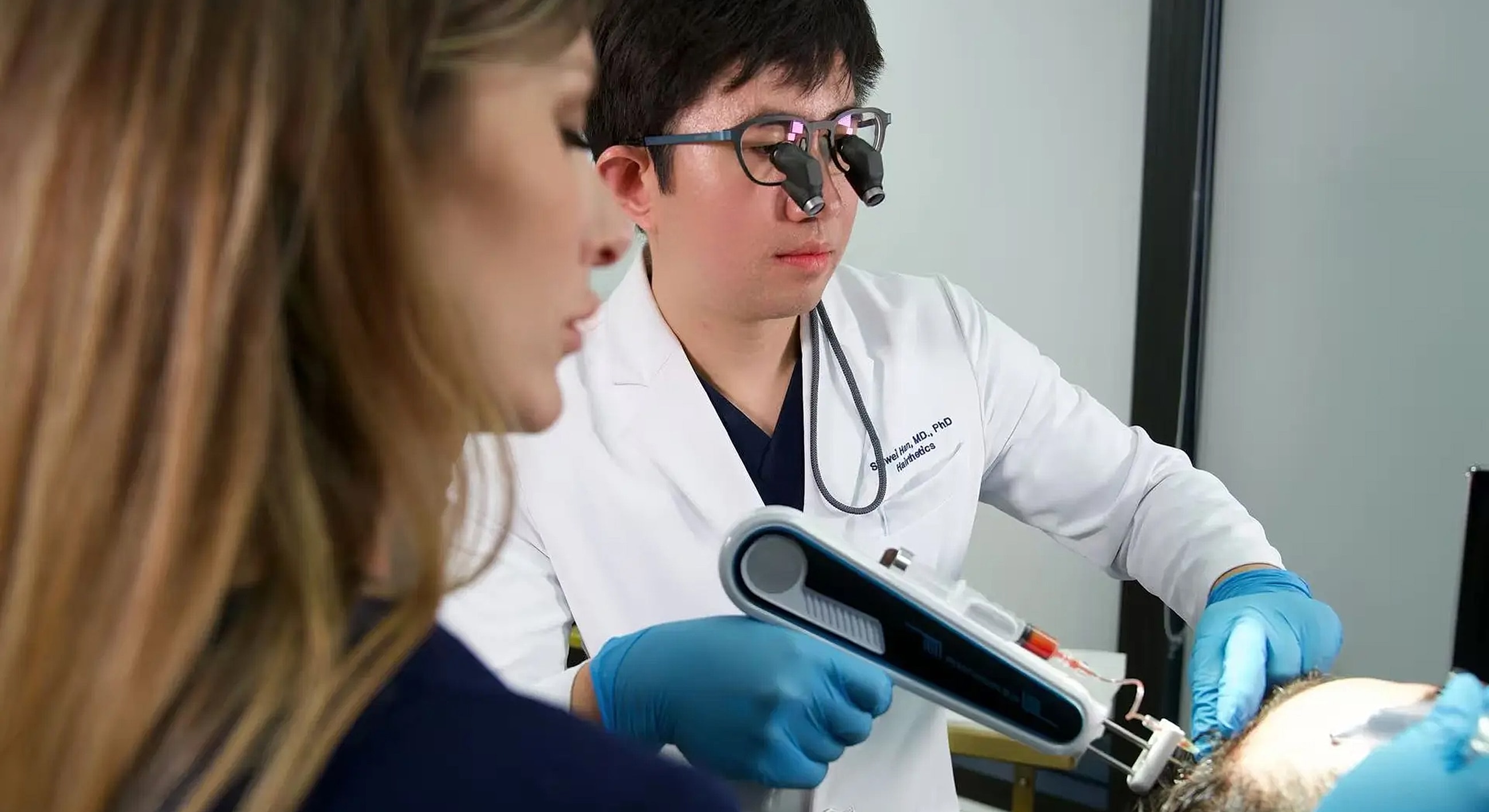 Doctor performing a medical procedure on a patient.