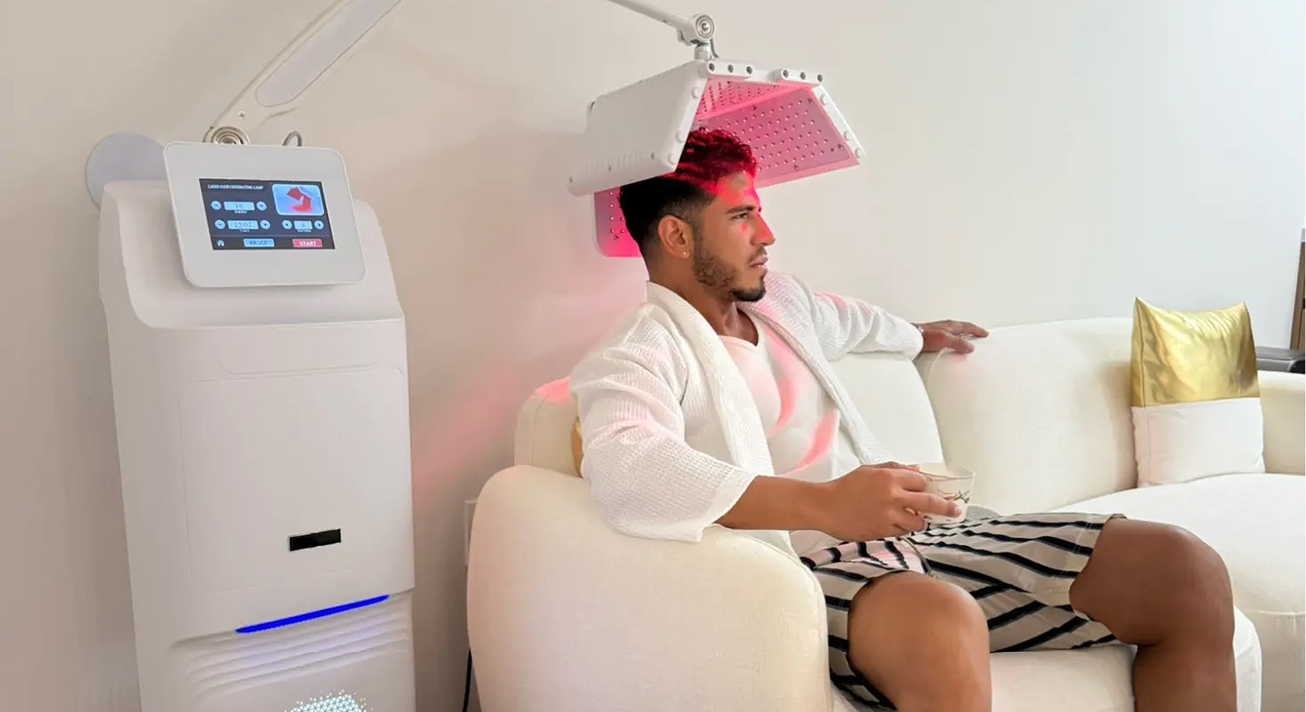 Man relaxing with laser hair treatment device.